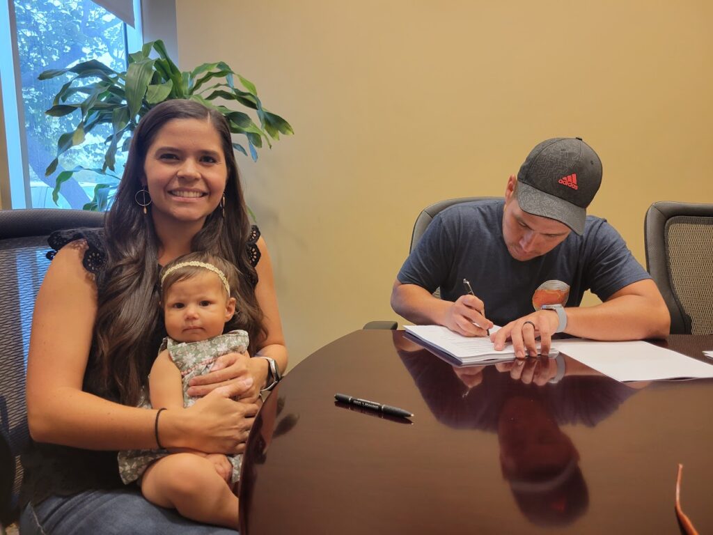 Buyers signing closing documents in Liberty Hill, TX